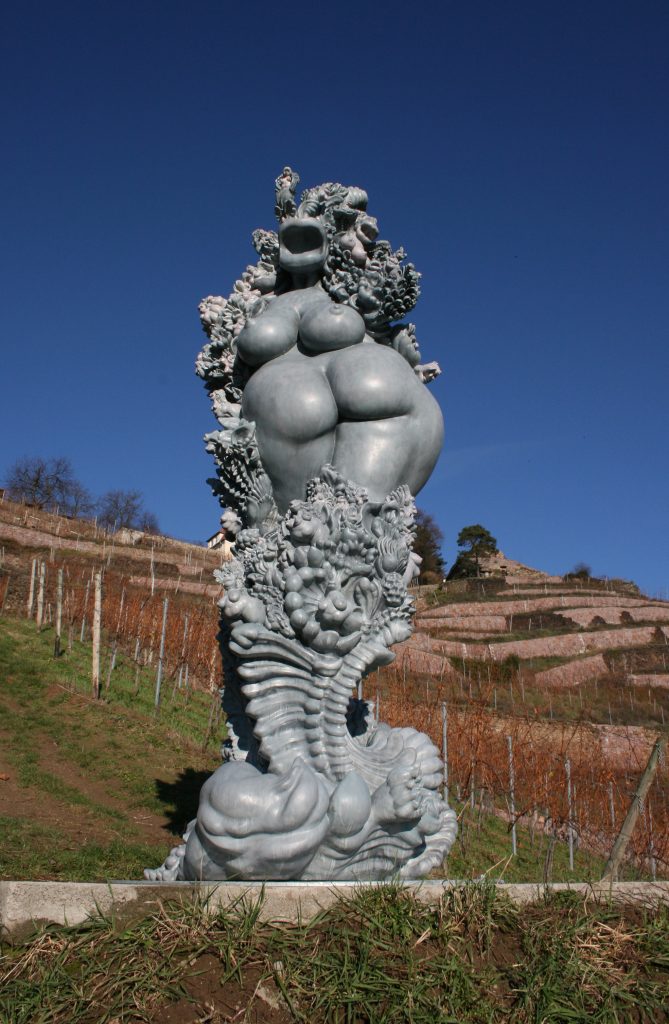 miriamlenk janusfee 2015.  an abstracted, Janus-headed torso of a voluptuous woman in the middle of wildly proliferating ornaments, plants and mixed creatures of woman, plant and animal. epoxy resin blue-grey patinated 1/5 at the winery dreiherren collection Rainer Beck. R