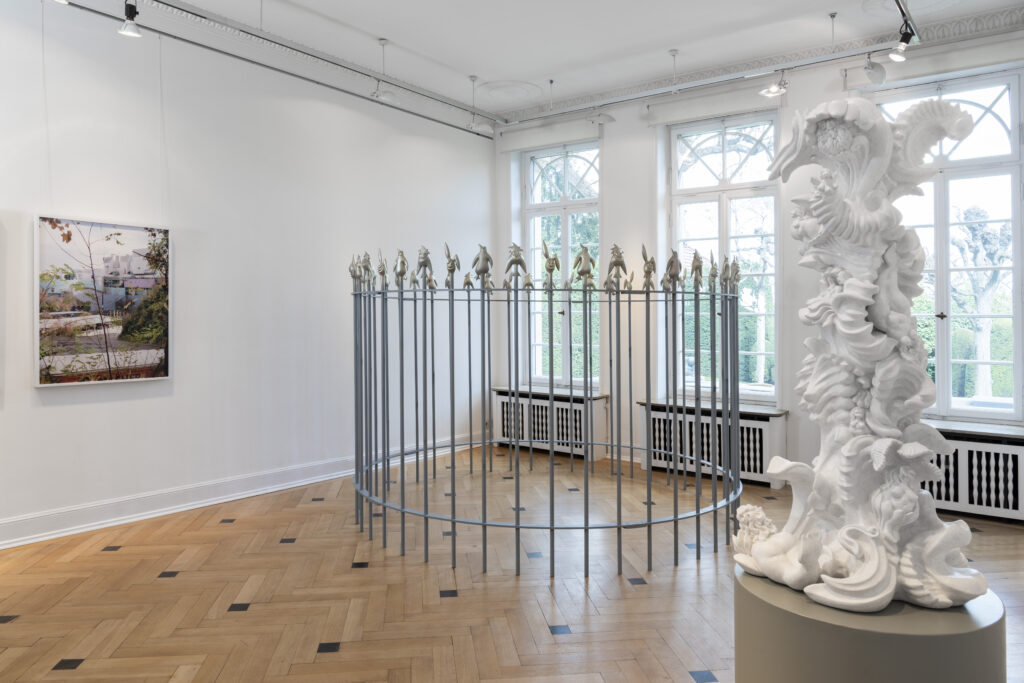miriamlenk inception a column of ornaments.acrystal white patinated, 112x 55x 45cm, female figures and mixed creatures. exhibition view with photo by Anette Kelm and grid by Mathias Megyeri